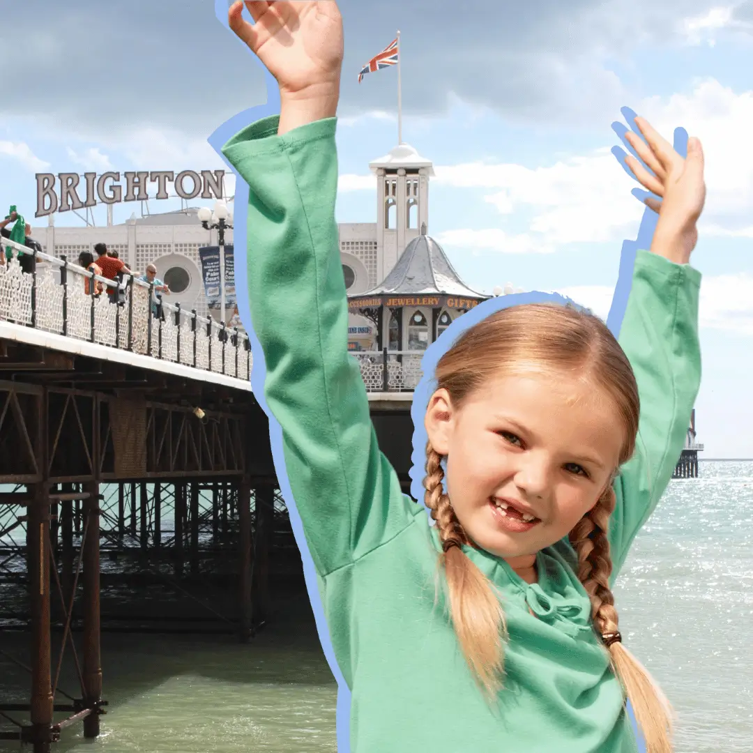 a girl with her arms up in the air. Fun Things To Do In Brighton